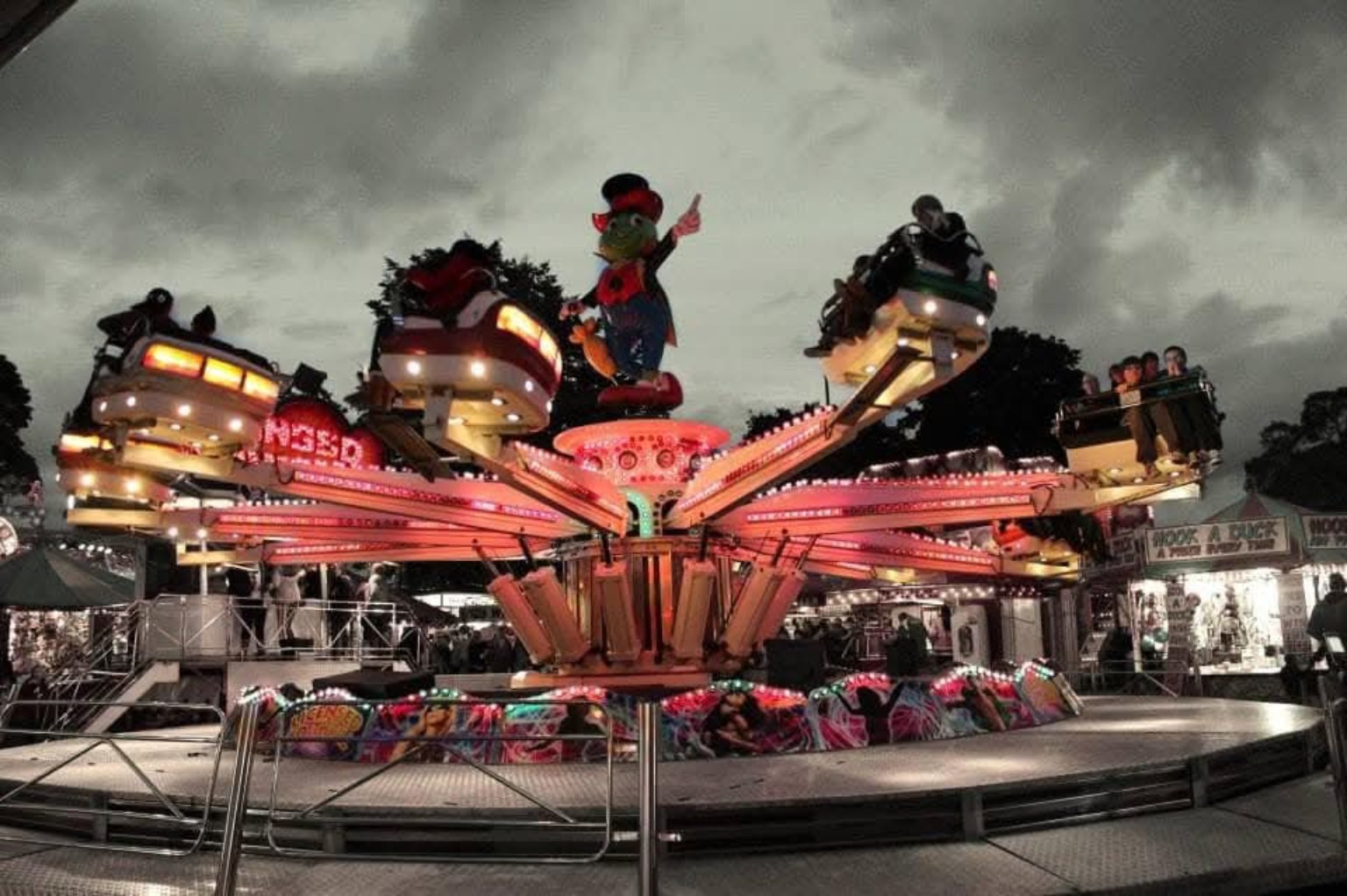 A fairground ride under stormy skies
